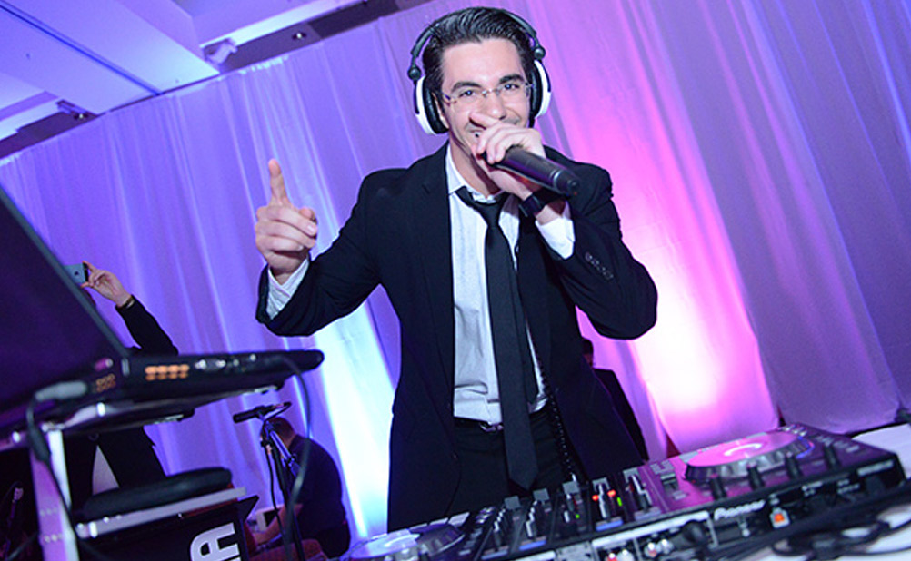 Event DJ stands with mic and headphones on