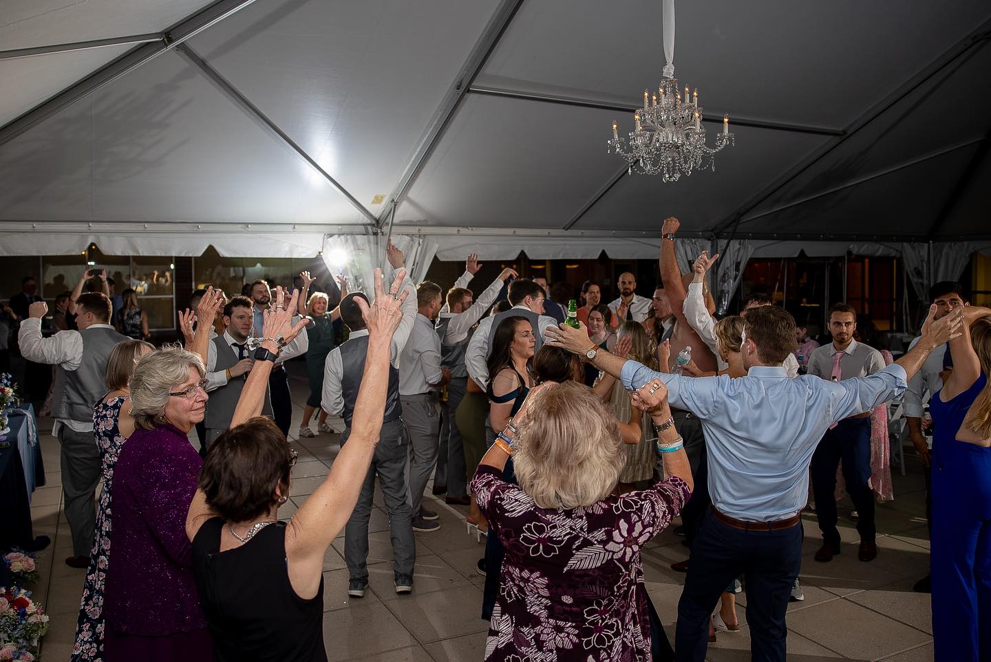 Big crowd of people at a wedding dancing to music
