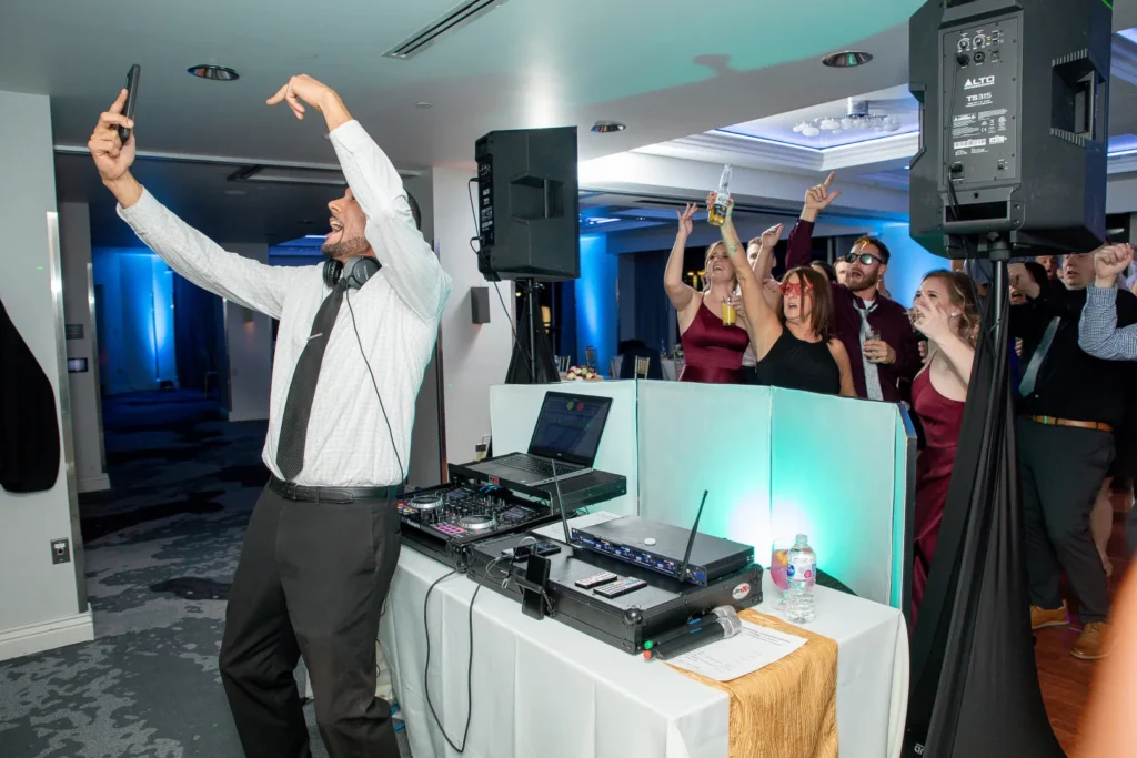 DJ interacting with guests dancing at a wedding reception