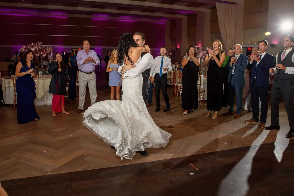 Bride and groom dancing in the middle of a circle of guests