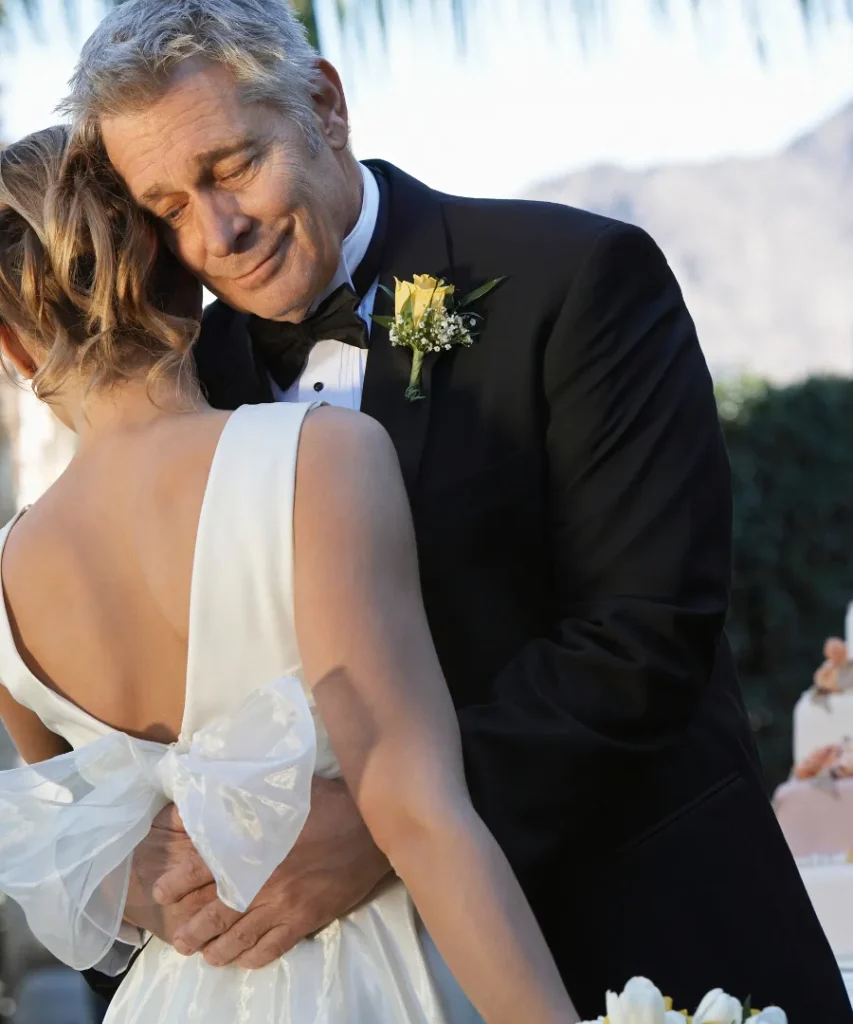 Father hugging daughter at wedding