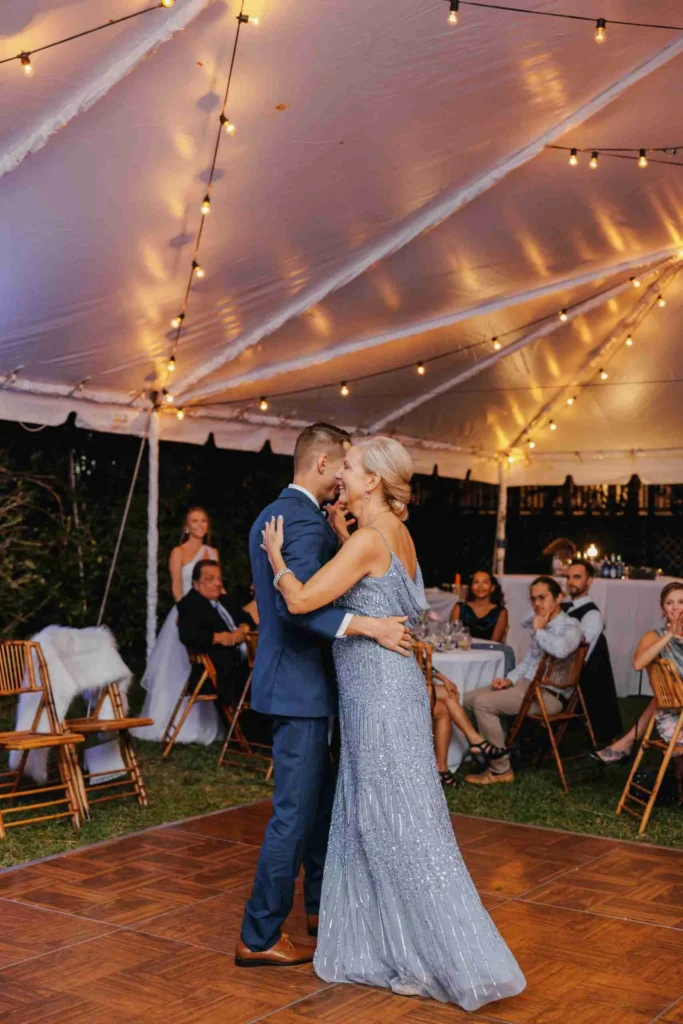 Mother of the groom dancing with her son at wedding
