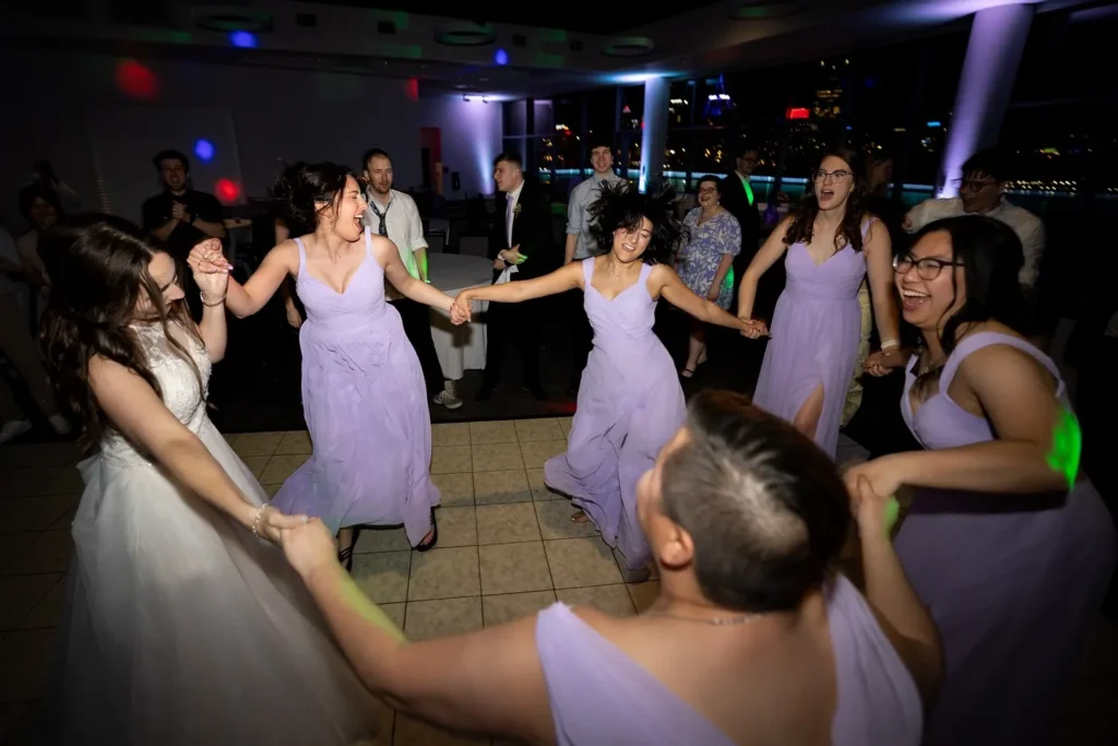 bridesmaids dancing in circle on the wedding dance floor