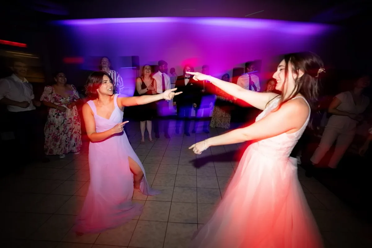 Dancing to Taylor Swift wedding songs on dance floor at wedding